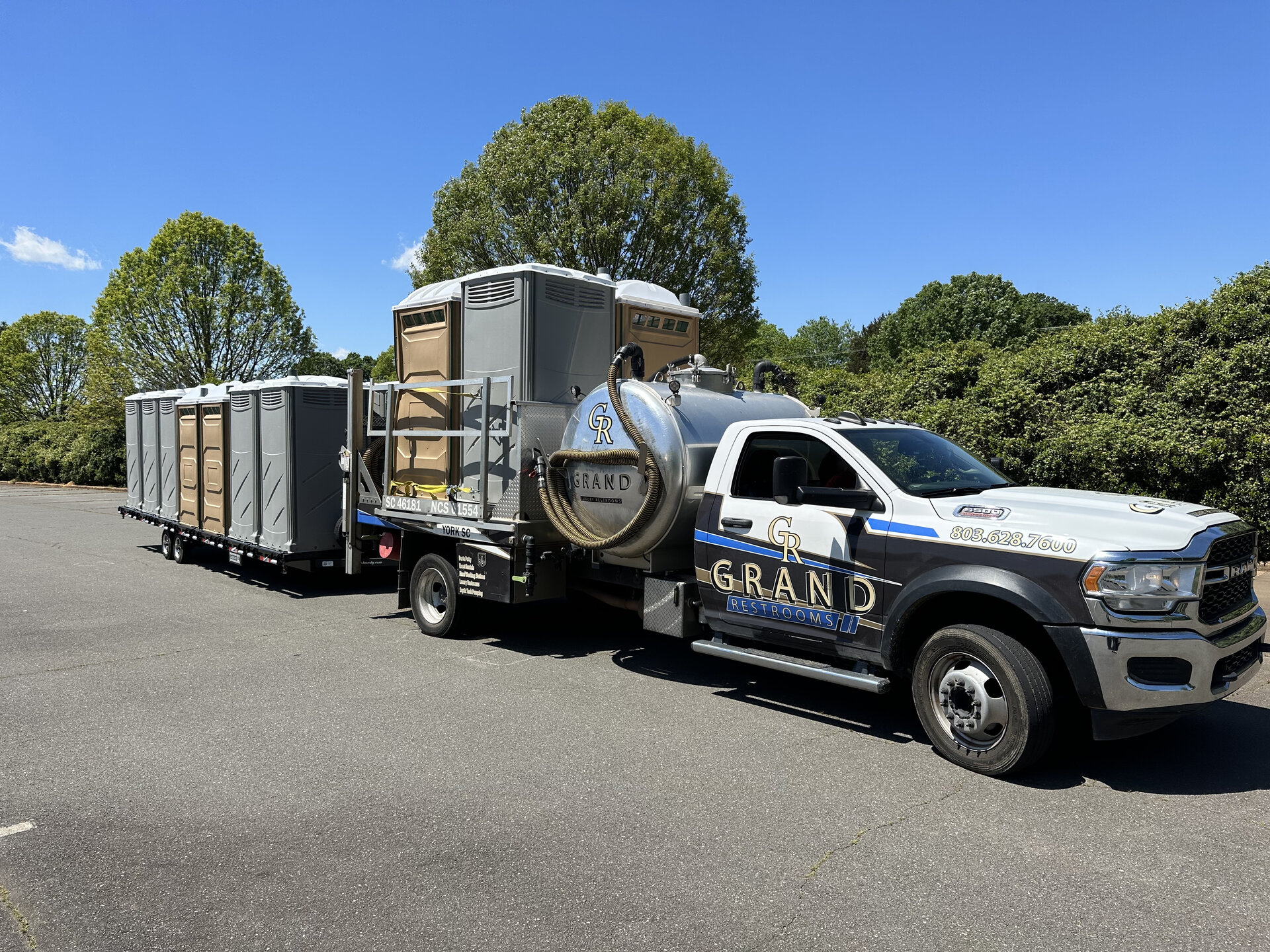 Grand Restrooms delivery fleet truck and trailer transporting luxury restroom trailers across the Carolinas
