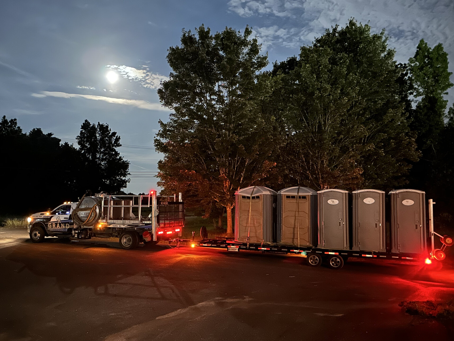 Grand Restrooms delivery fleet vehicle on site transporting luxury restroom trailers across the Carolinas