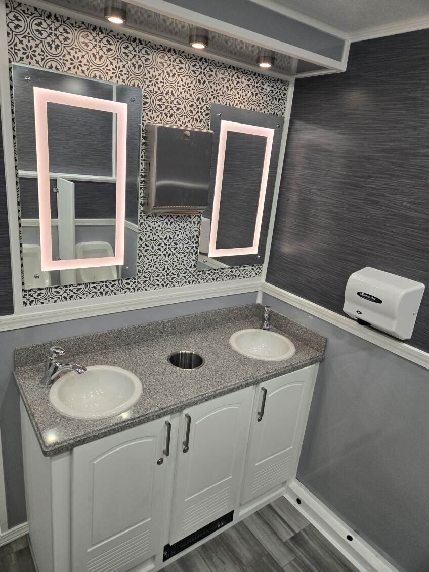 ADA compliant restroom trailer interior with grab bars and wide doorway