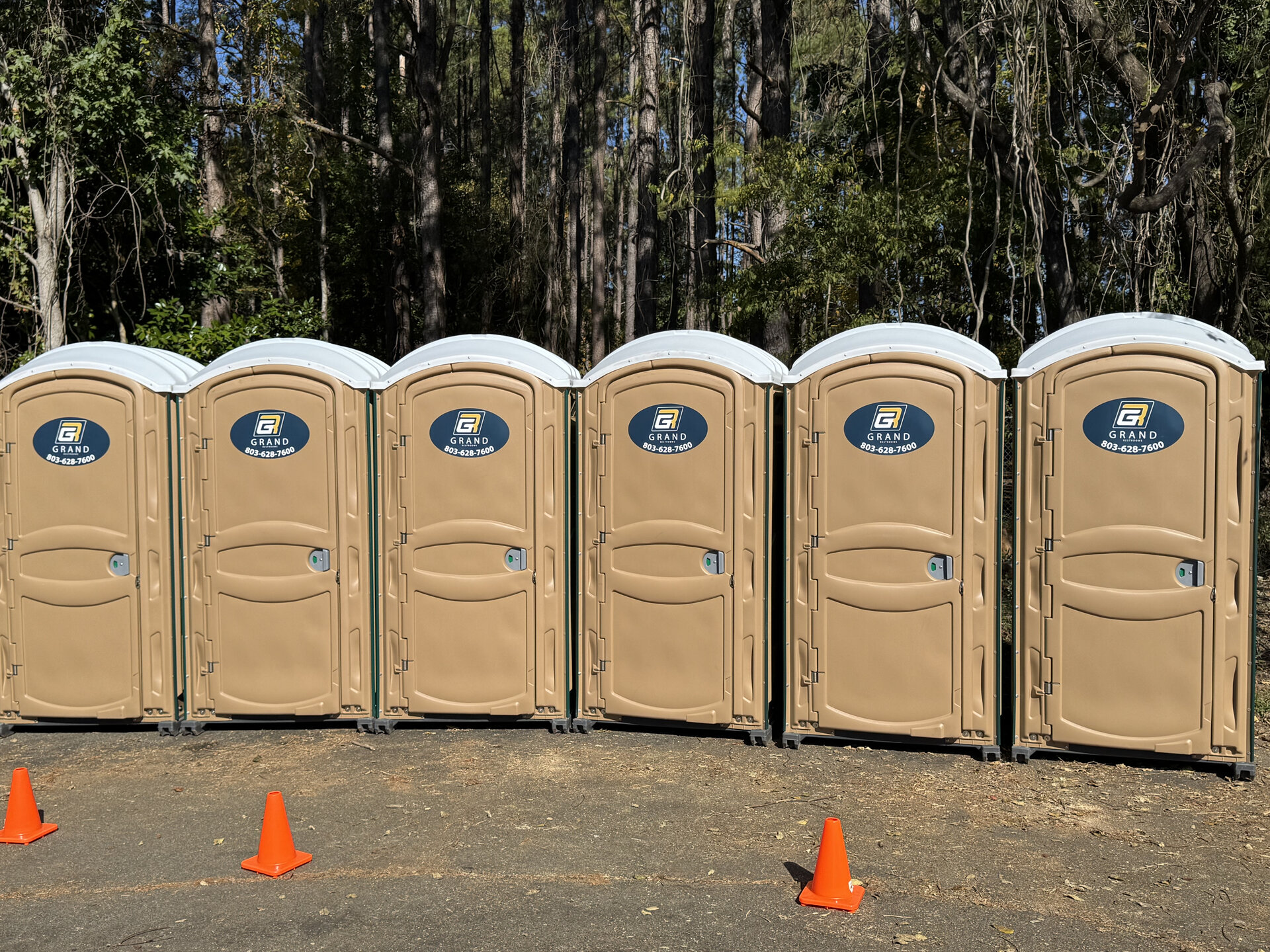 Grand Restrooms 5 station luxury restroom trailer with doors open at an outdoor venue