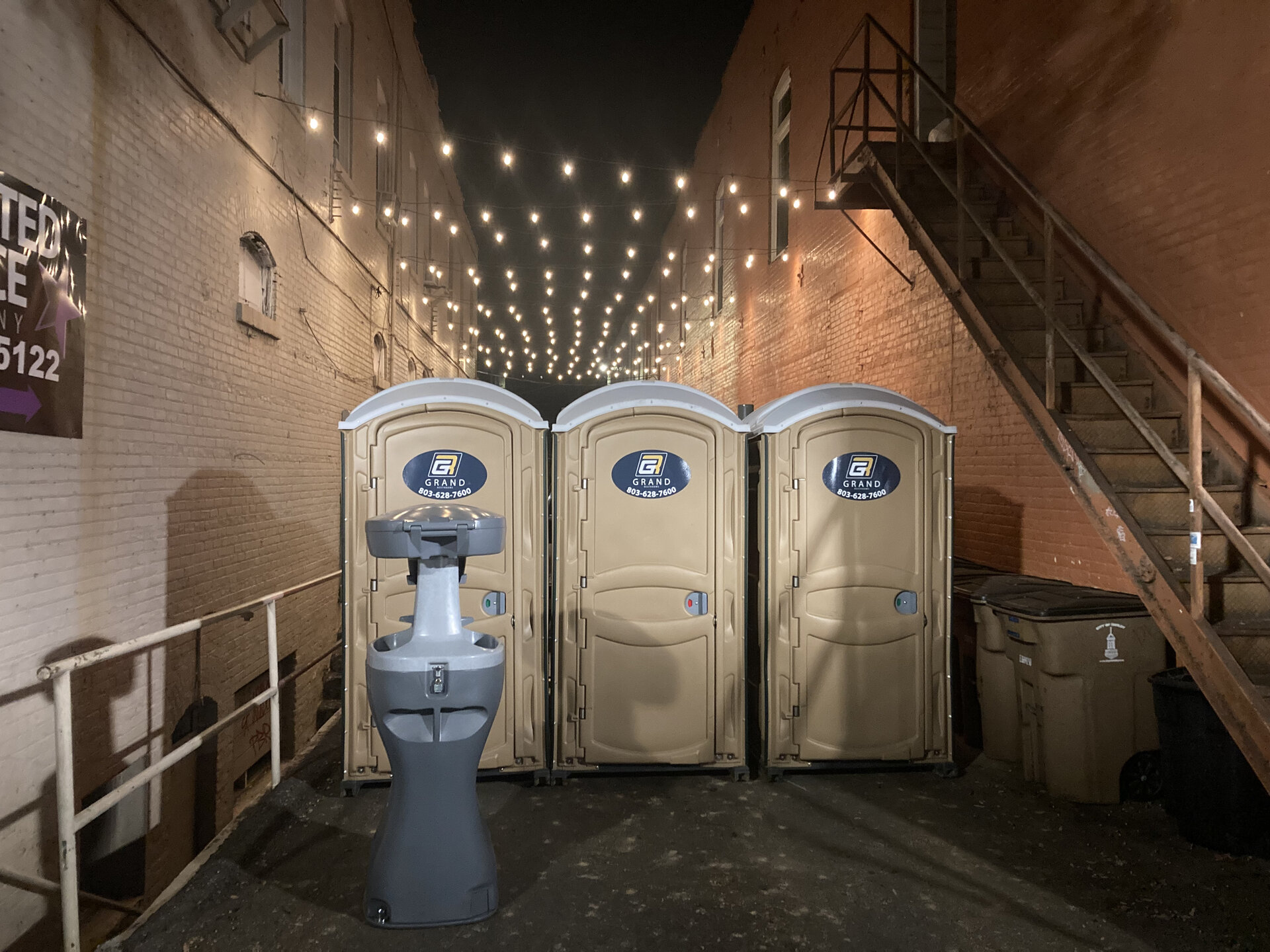 Portable restroom trailer setup daytime prepared by Grand Restrooms for Carolina festivals