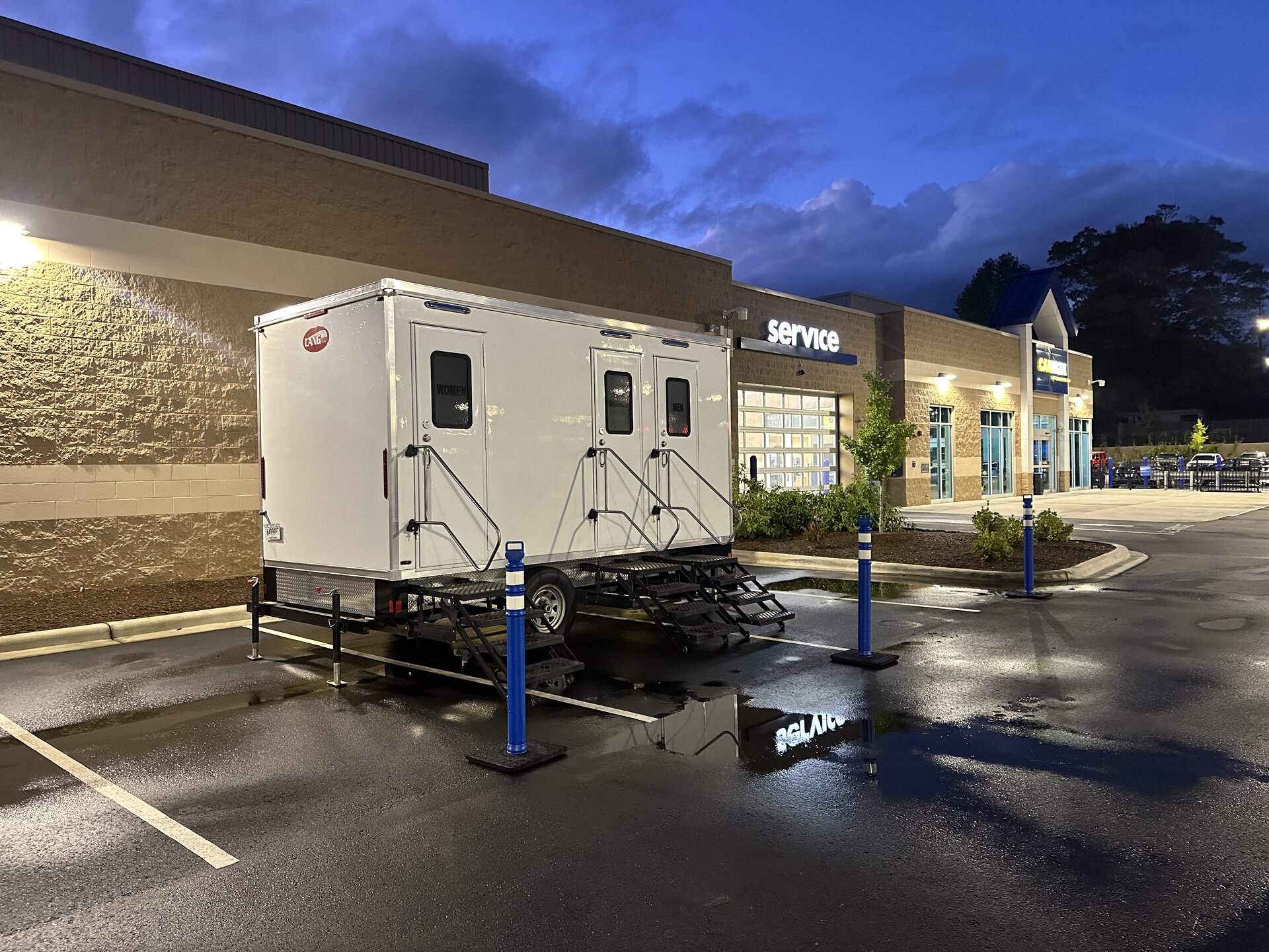 High-rise portable restroom being positioned with rigging